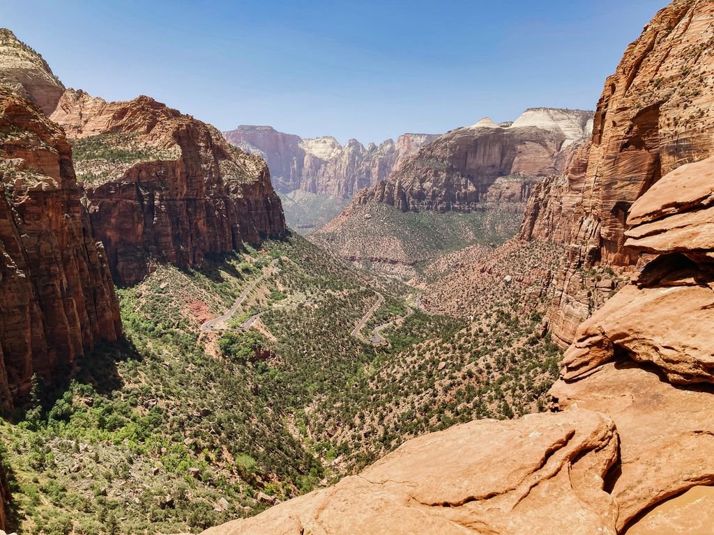 Stunning aerial view of Zion National Park's rugged canyons and vibrant landscape under a clear blue sky.
