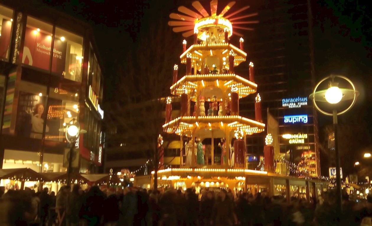 Large illuminated German Christmas pyramid at a Christmas market at night