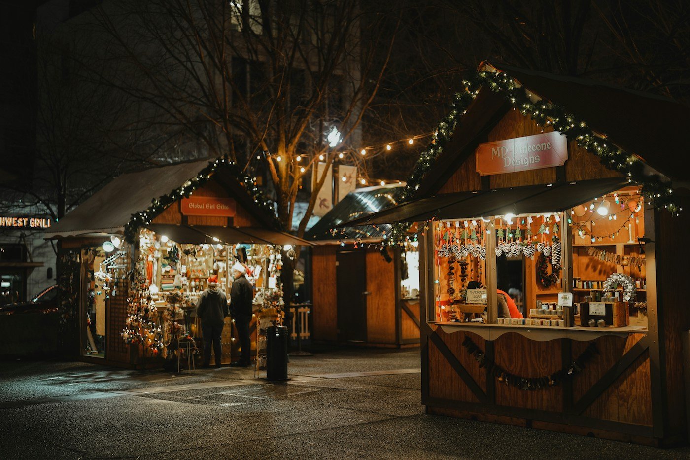 Wooden chalets lit up at night at the Pittsburgh Christmas market